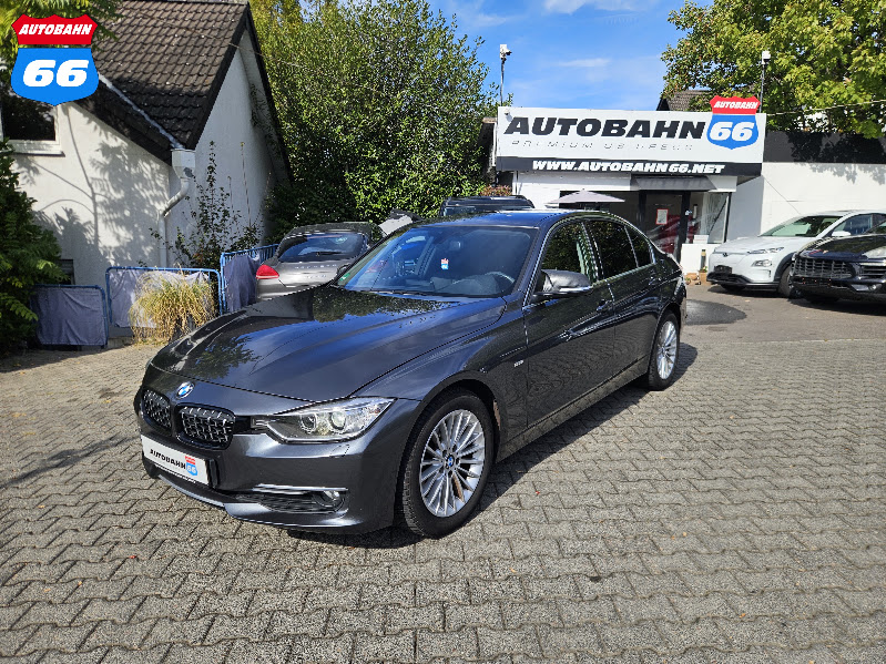 2014 BMW 318d in front of Autobahn 66 car sales